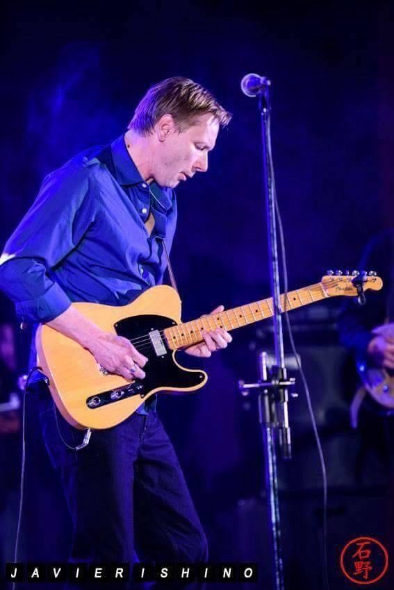 Pete Schmidt playing a Telecaster under blue stage light